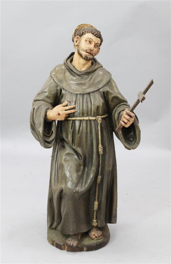A parcel gilt painted wood altar figure of St Francis, 3ft